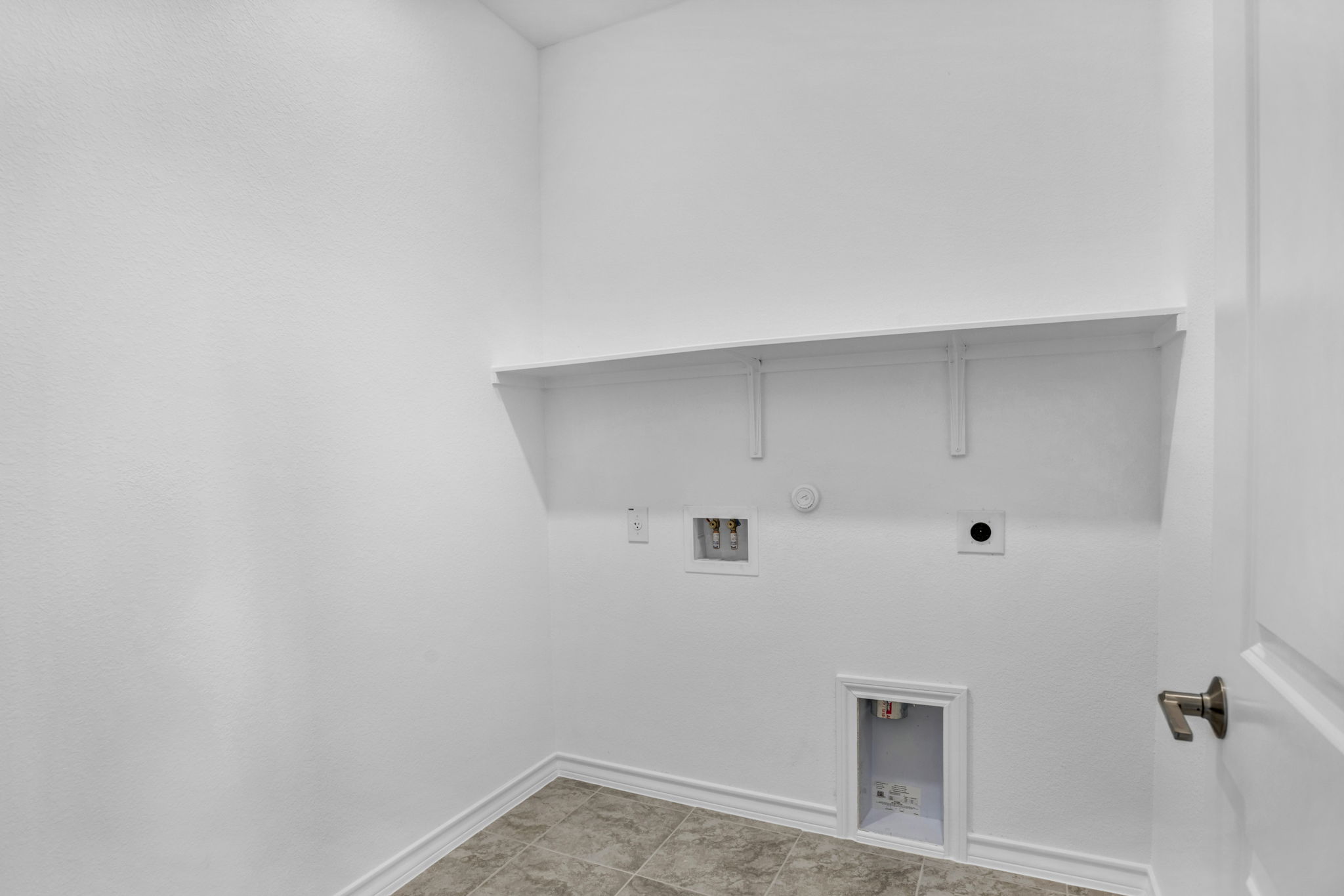 131 Adeline Road Hutto, TX 78634 - Photo 26 of 30 A dedicated laundry space provides practical utility with easy hookups.