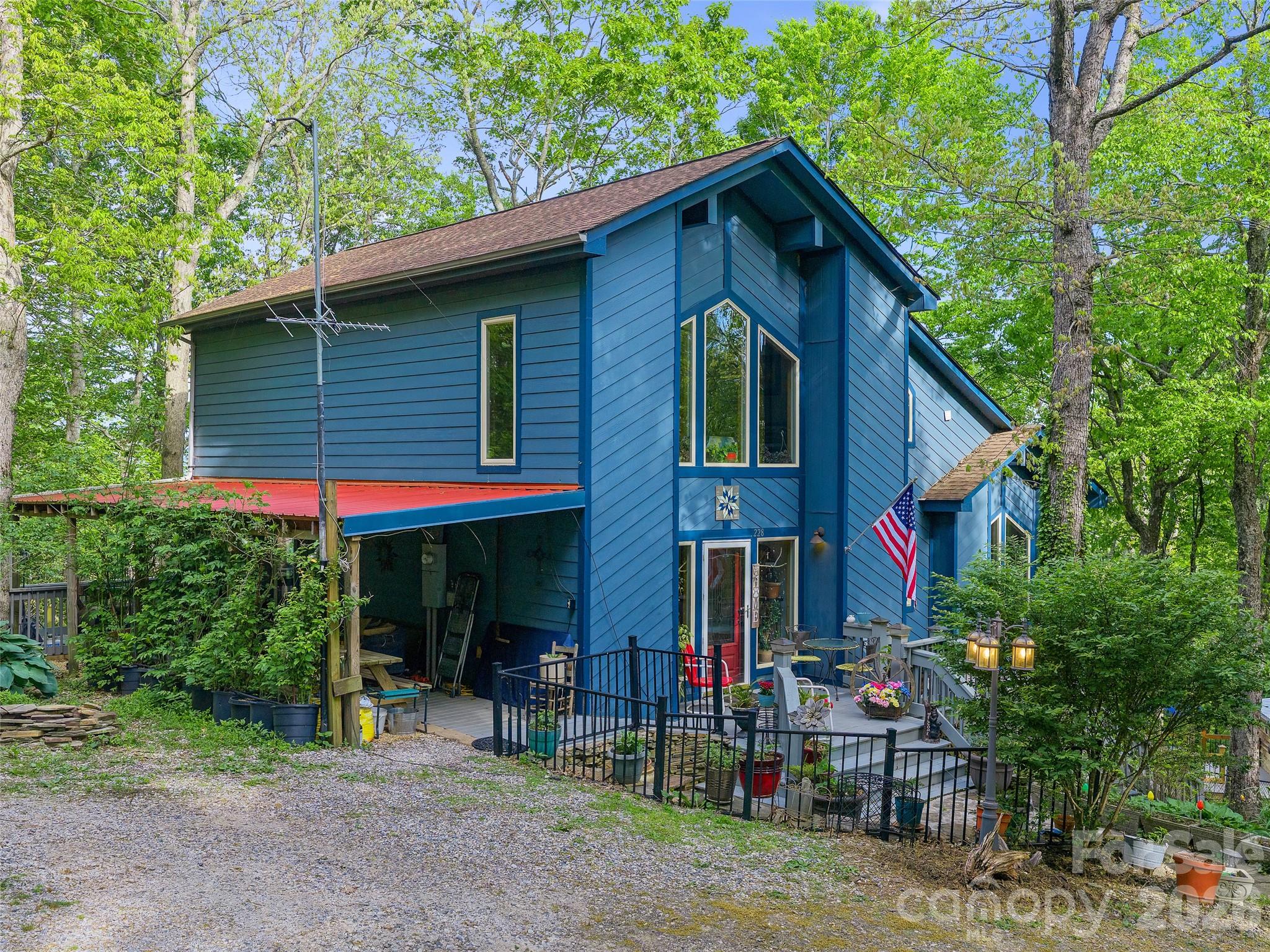 228 Continental Divide Road Spruce Pine, NC 28777 - Photo 30 of 48 a view of a house with a yard and sitting area