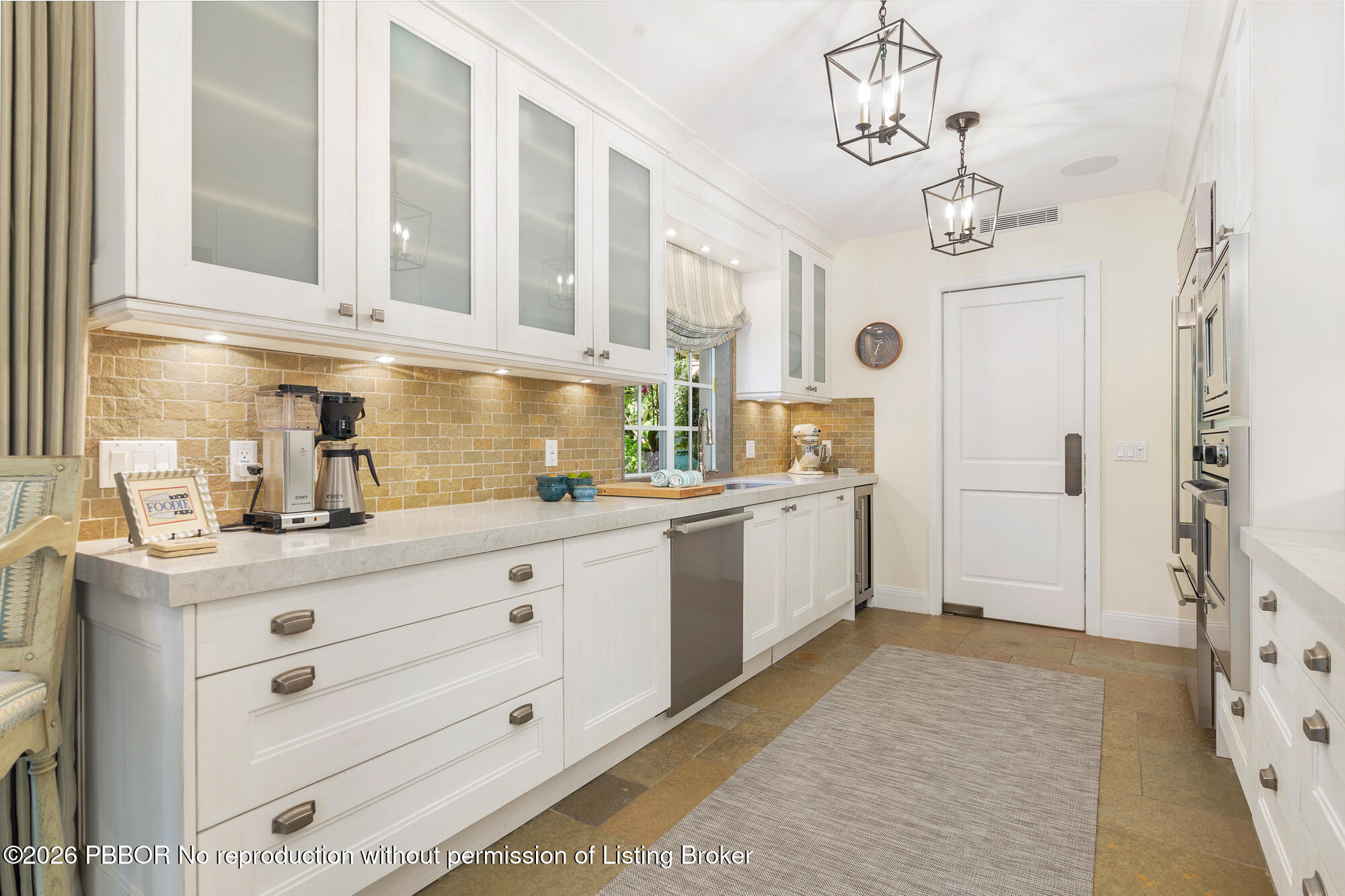 111 Seagate Road Palm Beach, FL 33480 - Photo 10 of 35 a kitchen with cabinets stainless steel appliances and a counter