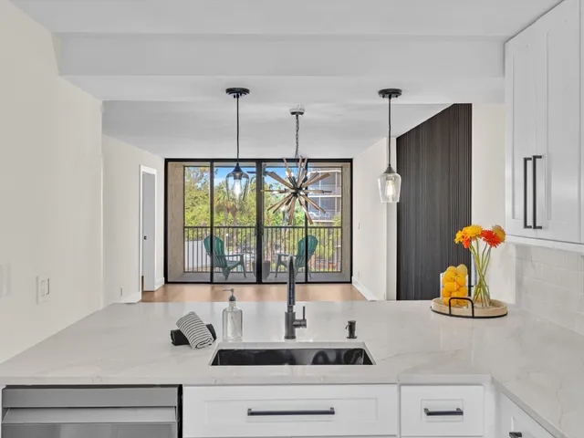 a kitchen with a sink and a large window