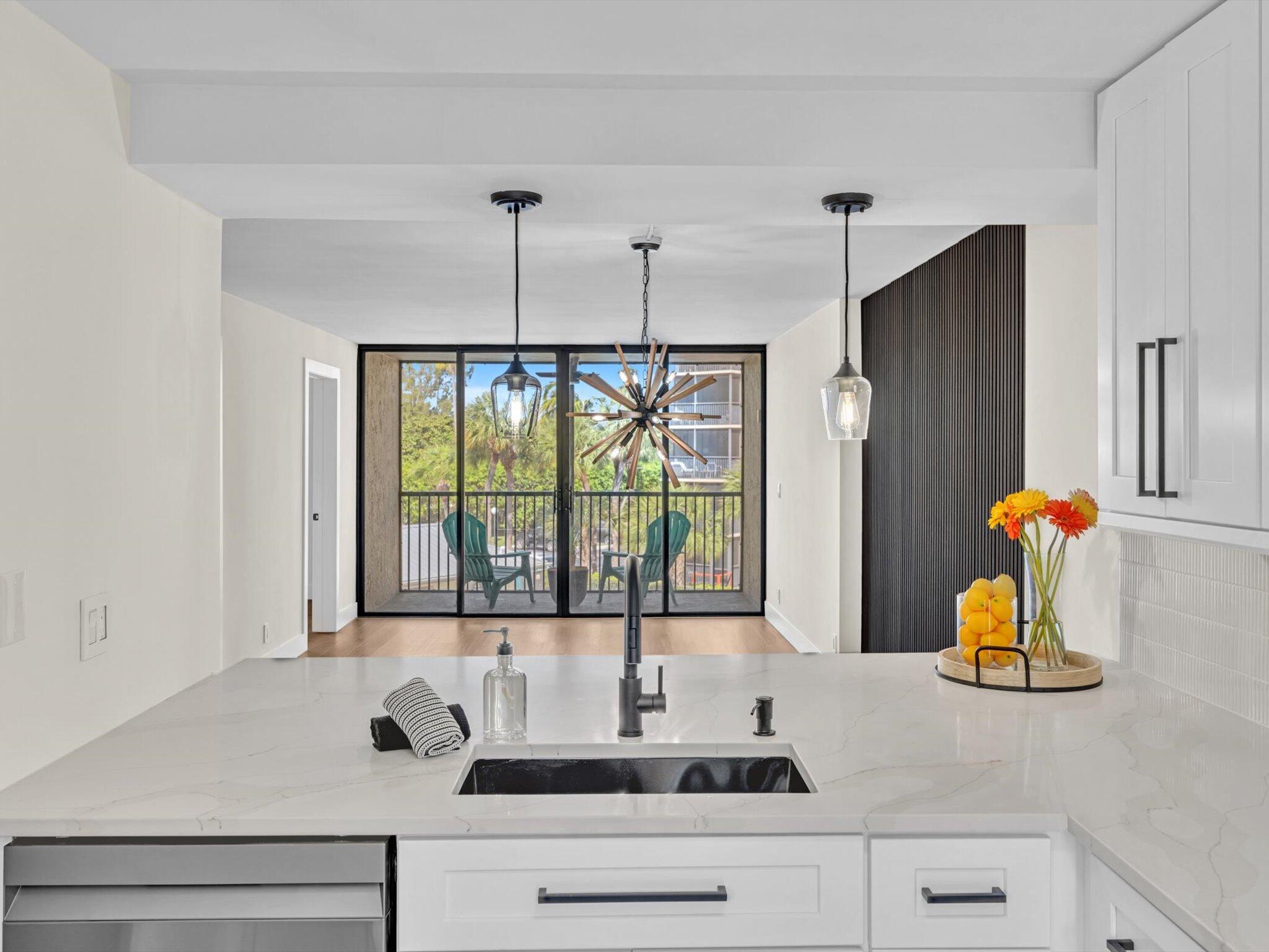 a kitchen with a sink and a large window
