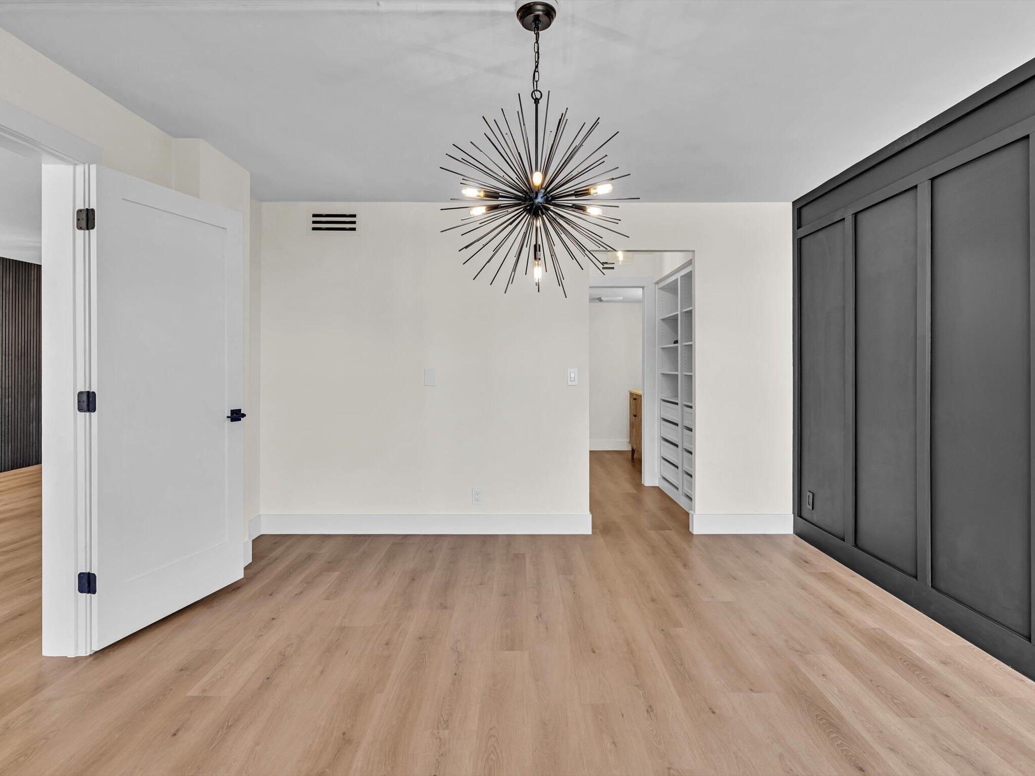 21 Royal Palm Way, Unit 303 Boca Raton, FL 33432 - Photo 19 of 38 a view of empty room with wooden floor and a ceiling fan