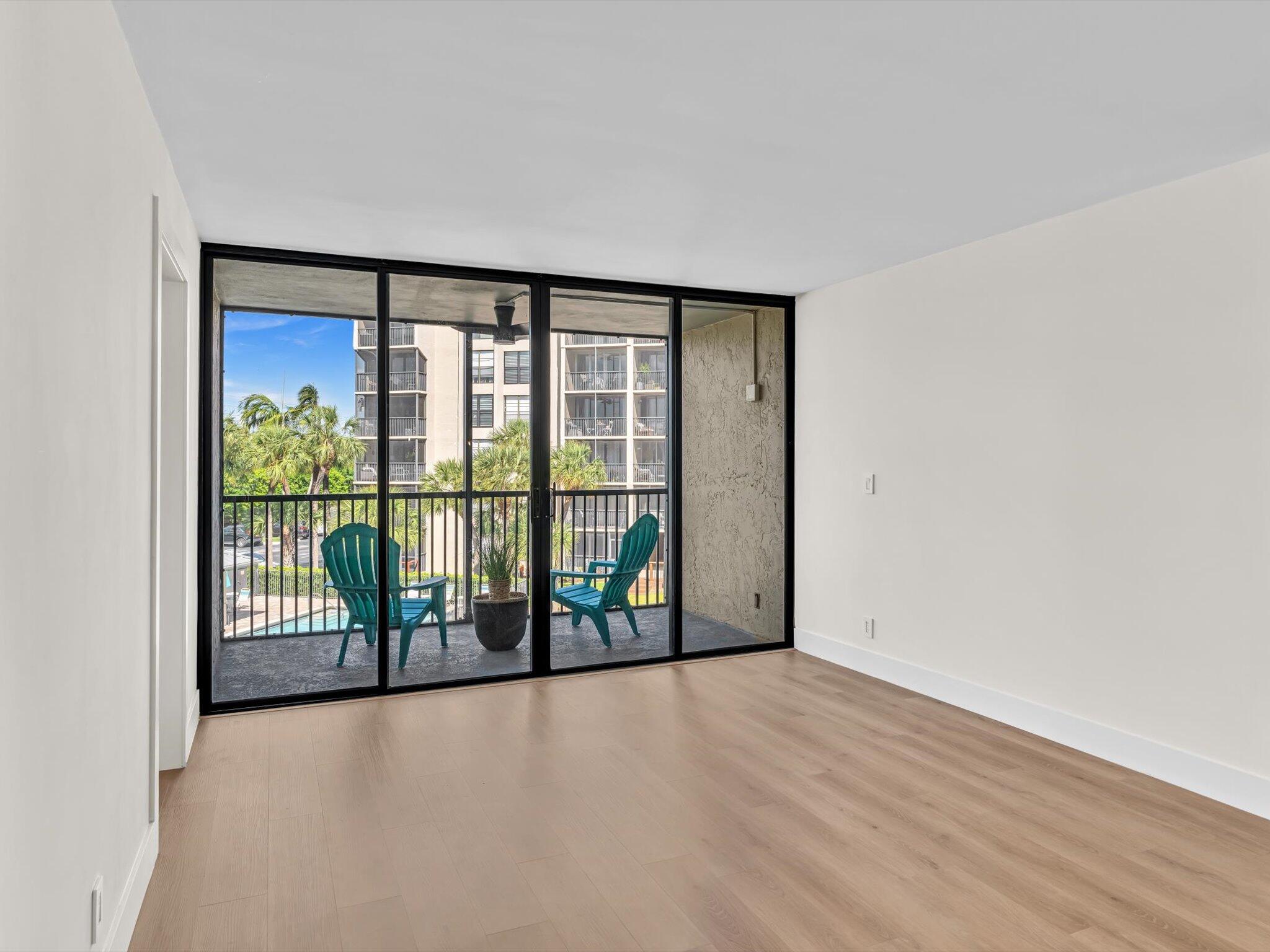 21 Royal Palm Way, Unit 303 Boca Raton, FL 33432 - Photo 29 of 38 en empty room with sliding door and mountain view