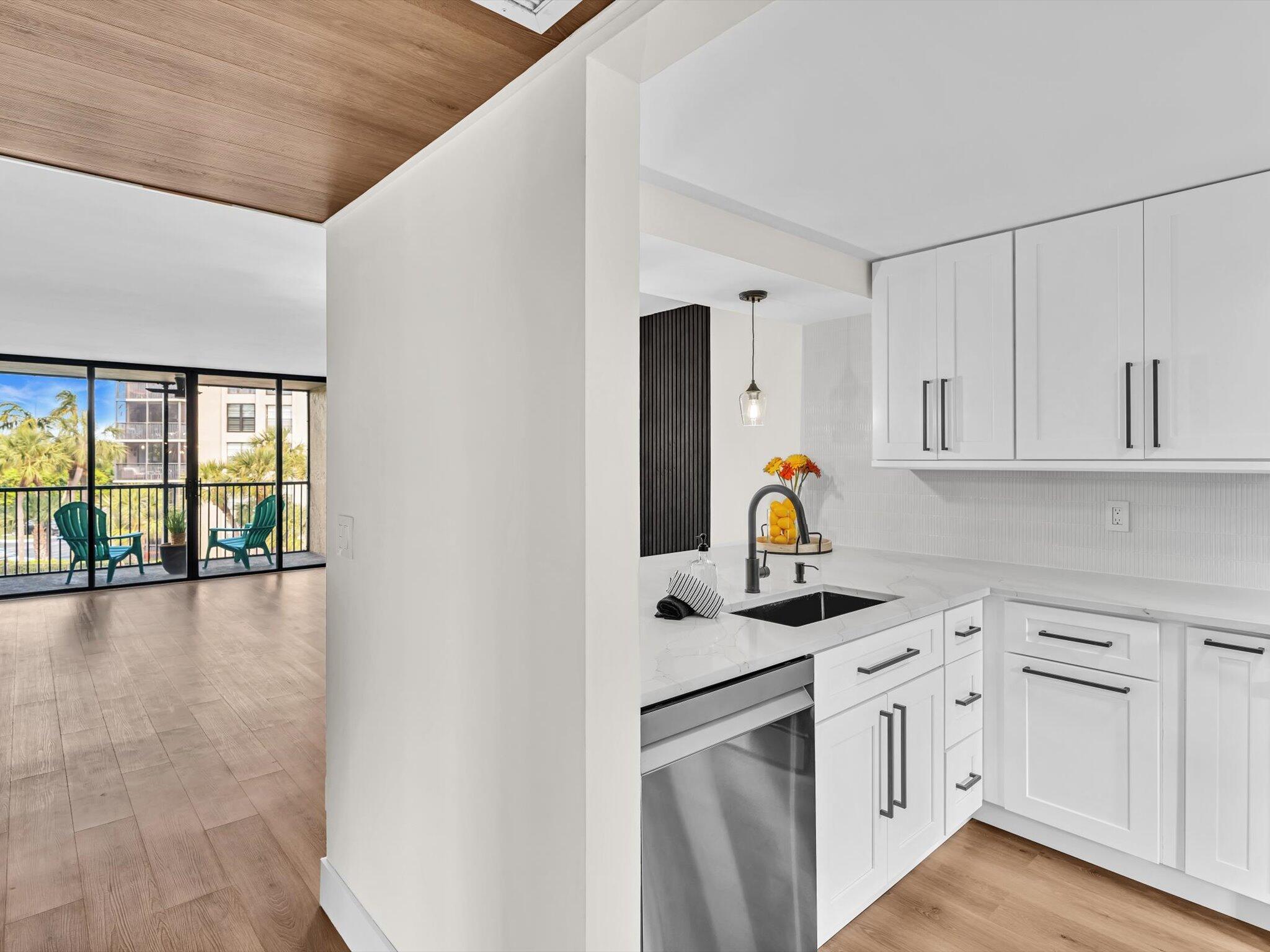 21 Royal Palm Way, Unit 303 Boca Raton, FL 33432 - Photo 5 of 38 a kitchen with white cabinets and appliances