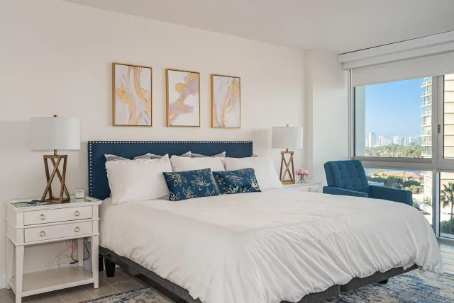 a bedroom with a large bed and a window