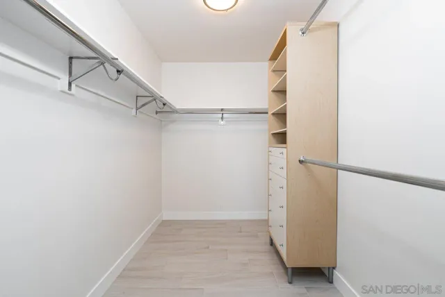 a view of walk in closet with empty racks
