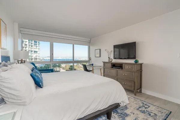 a bedroom with a bed and a flat screen tv