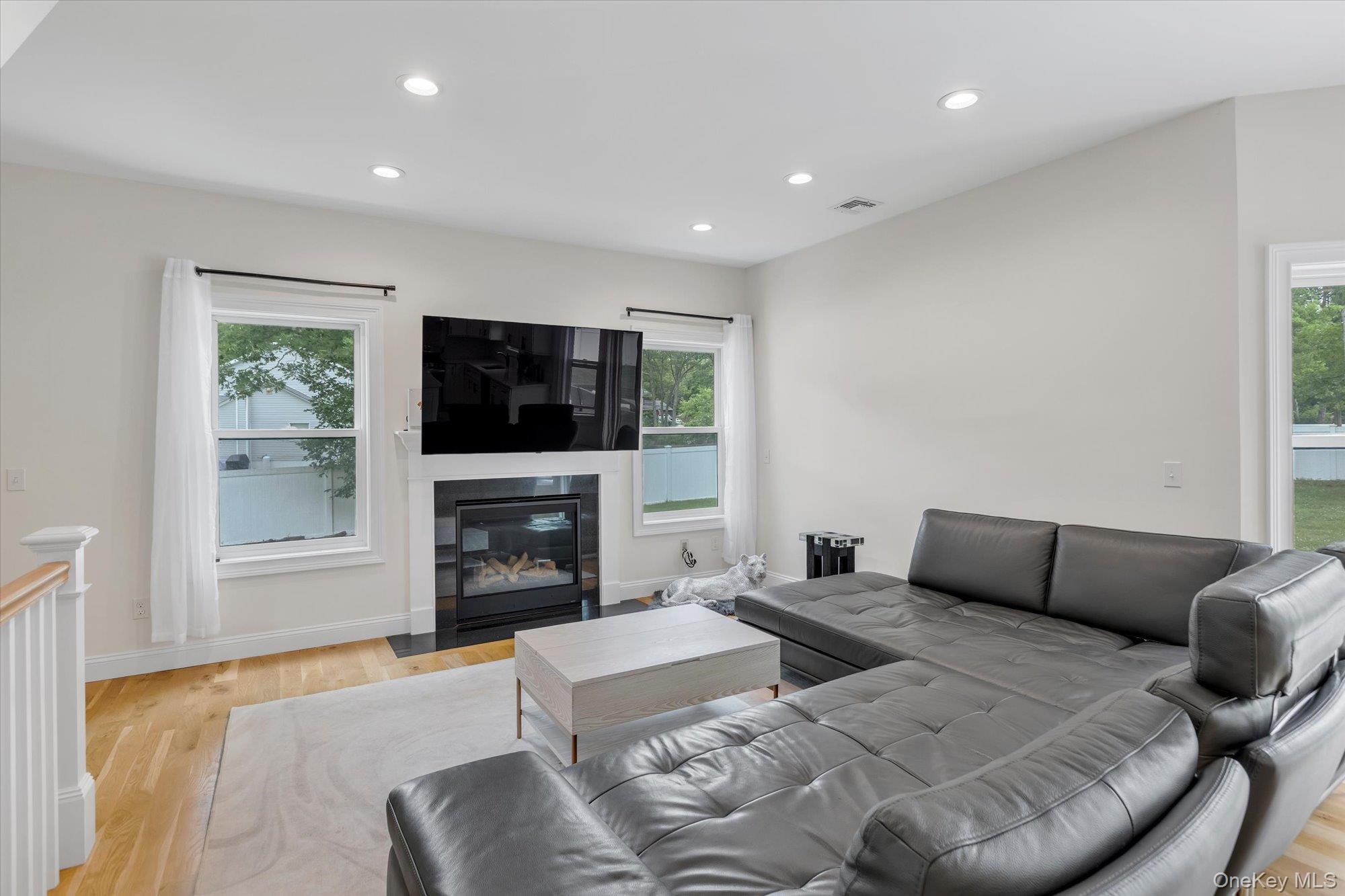 135 Elizabeth Way Ridge, NY 11961 - Photo 5 of 24 a living room with furniture fireplace and flat screen tv