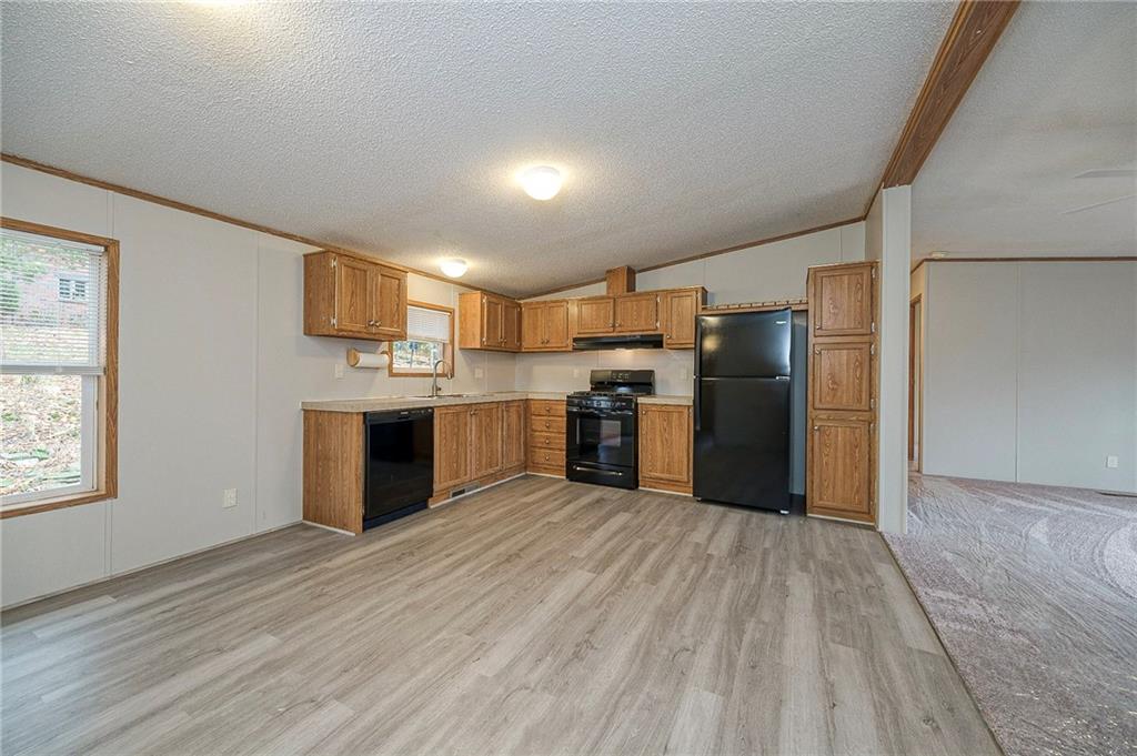 3454 Evergreen Road Pittsburgh, PA 15237 - Photo 11 of 25 a kitchen with stainless steel appliances a refrigerator and a wooden floor