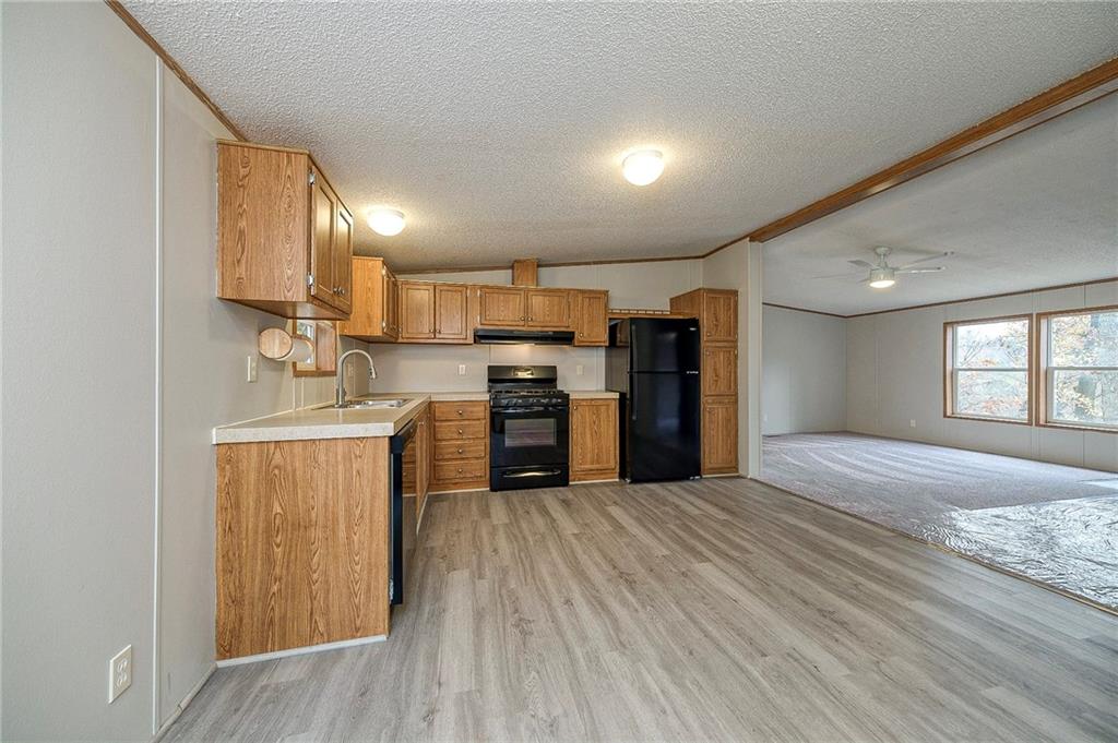 3454 Evergreen Road Pittsburgh, PA 15237 - Photo 12 of 25 a kitchen with stainless steel appliances kitchen island granite countertop a refrigerator and a stove top oven