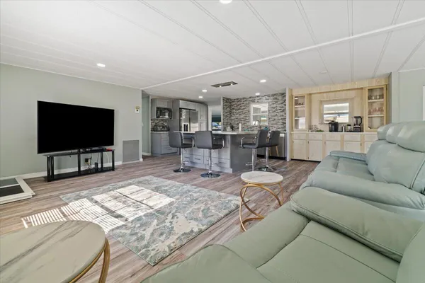 a bedroom with bed and wooden floor