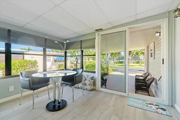 a living room with furniture flat screen tv and a large window