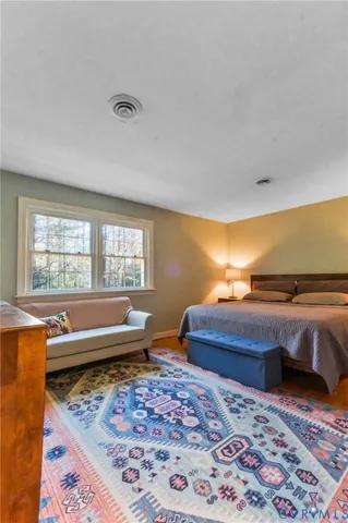 a living room with couches rug and a table