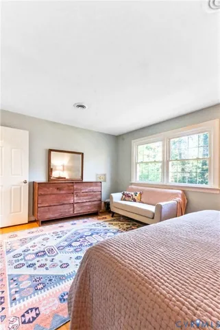 a bedroom with furniture and a large window