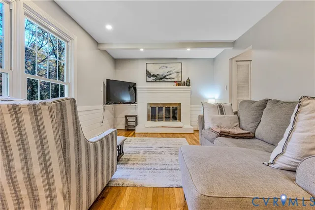 a living room with furniture fireplace and flat screen tv