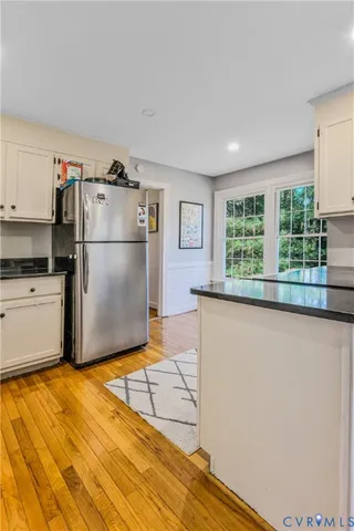 a kitchen with a refrigerator a stove and a window