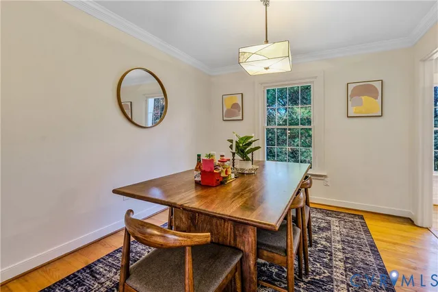 a view of a dining room with furniture and a window