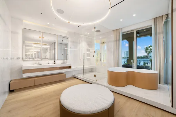 a bathroom with a sink a toilet a mirror and shower