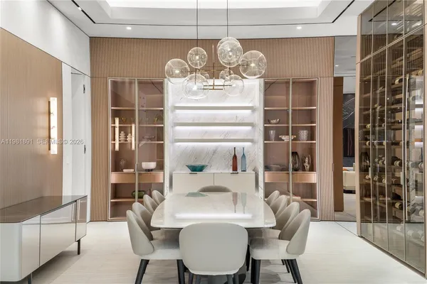 a view of a dining room with furniture and chandelier