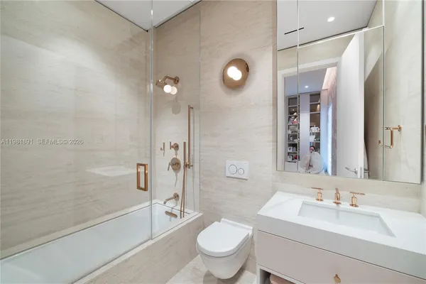 a bathroom with a granite countertop sink a mirror and shower