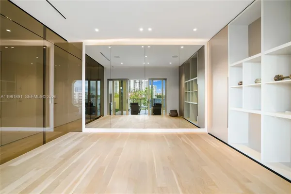 a view of a hallway to a livingroom and a livingroom with furniture
