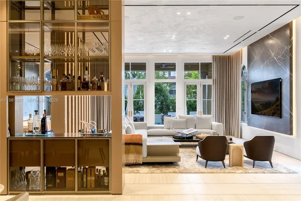a living room with furniture a flat screen tv and a floor to ceiling window