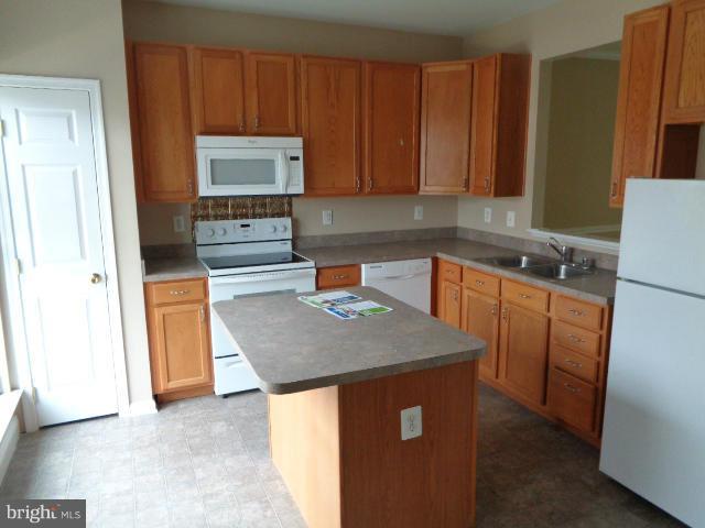 1736 Waltman Road Edgewood, MD 21040 - Photo 4 of 21 a kitchen with stainless steel appliances granite countertop a sink stove and refrigerator