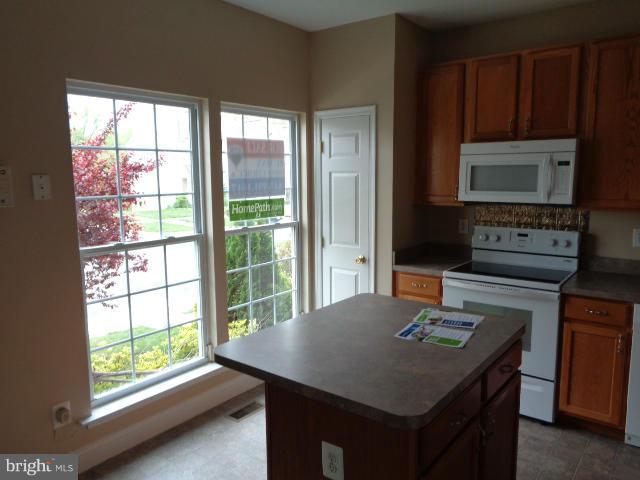 1736 Waltman Road Edgewood, MD 21040 - Photo 5 of 21 a kitchen with a stove a sink and a microwave