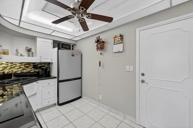 a kitchen with stainless steel appliances a refrigerator and a stove top oven