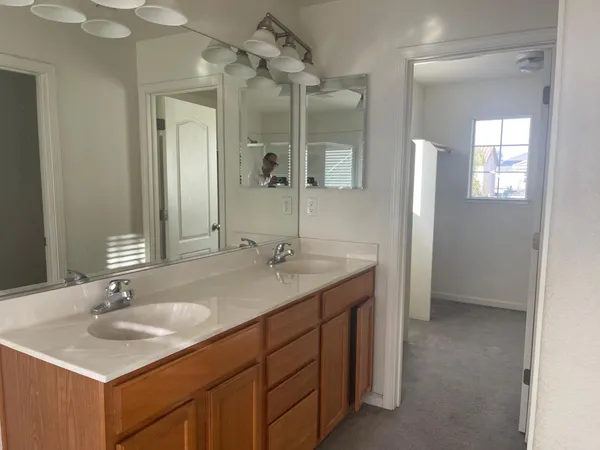 a bathroom with a sink double vanity granite and a mirror