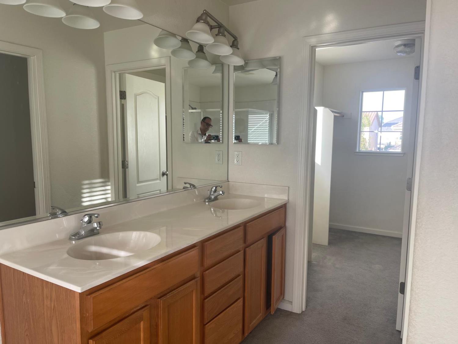 1006 Papaya Street Madera, CA 93638 - Photo 12 of 17 a bathroom with a sink double vanity granite and a mirror
