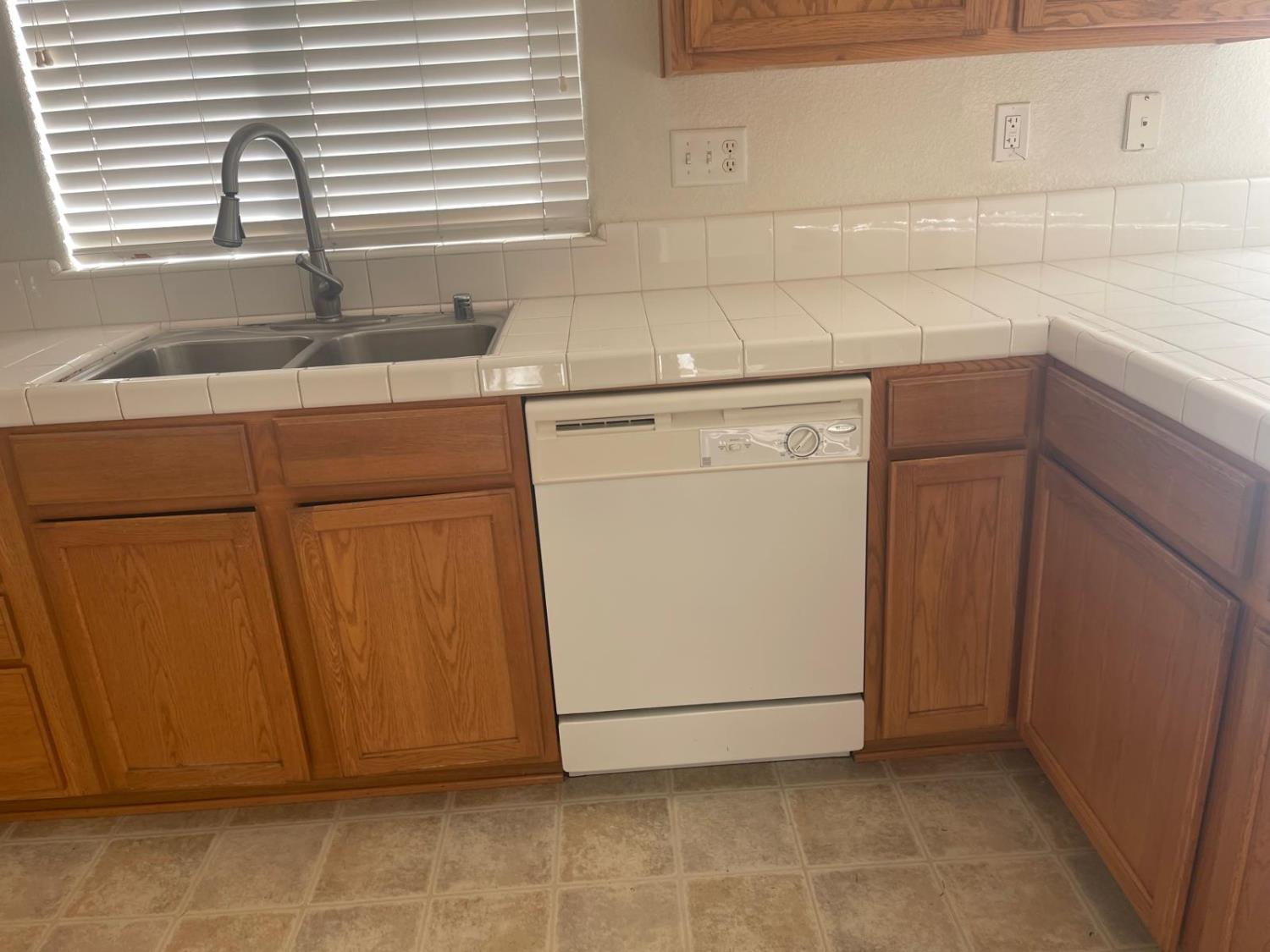 1006 Papaya Street Madera, CA 93638 - Photo 6 of 17 a kitchen with a sink cabinets and window