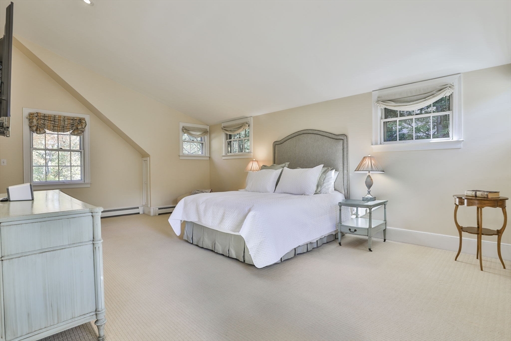 32 Columbine Road Milton, MA 02186 - Photo 22 of 40 a bedroom with a bed and a table in it