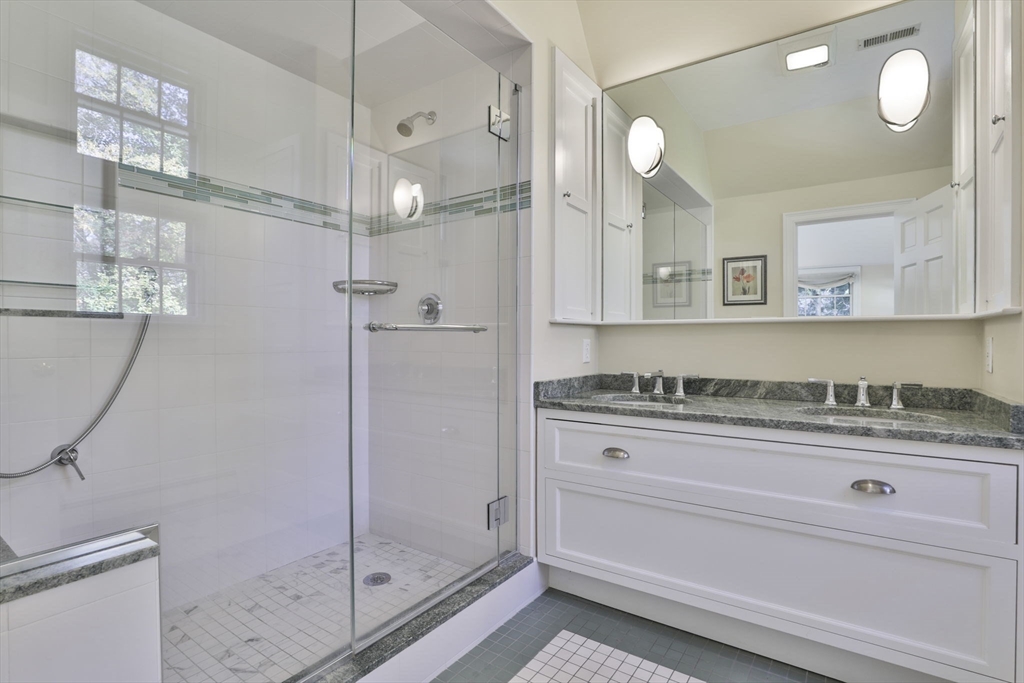32 Columbine Road Milton, MA 02186 - Photo 25 of 40 a bathroom with a granite countertop sink a mirror and shower
