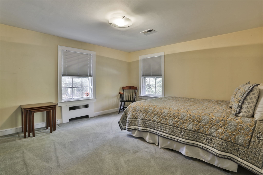 32 Columbine Road Milton, MA 02186 - Photo 27 of 40 a bed sitting in a spacious bedroom next to a window