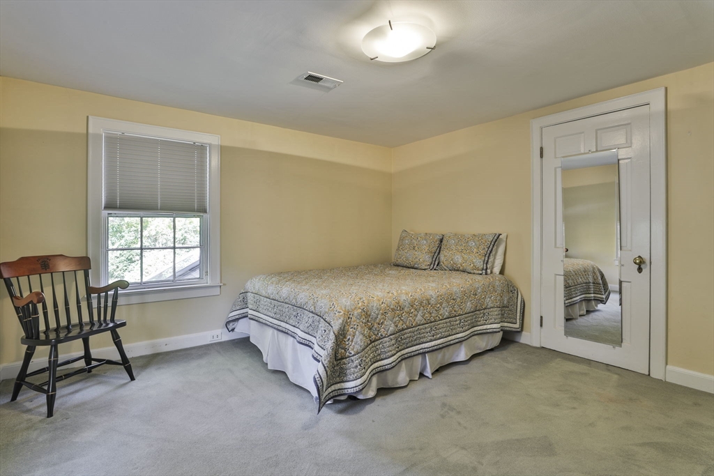 32 Columbine Road Milton, MA 02186 - Photo 28 of 40 a spacious bedroom with a bed and a window
