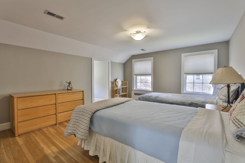 32 Columbine Road Milton, MA 02186 - Photo 29 of 40 a bedroom with a bed and a lamp on dresser