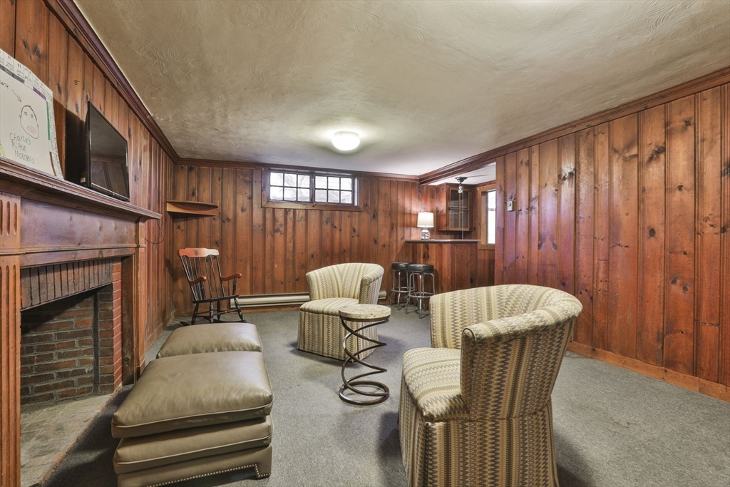 32 Columbine Road Milton, MA 02186 - Photo 33 of 40 a living room with furniture a fireplace and a flat screen tv