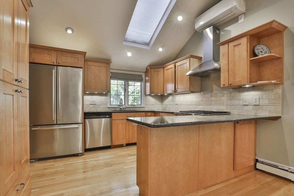 32 Columbine Road Milton, MA 02186 - Photo 8 of 40 a kitchen with granite countertop a refrigerator a sink and wooden cabinets