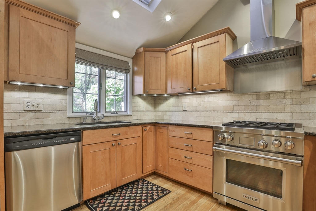 32 Columbine Road Milton, MA 02186 - Photo 9 of 40 a kitchen with granite countertop a stove sink and cabinets