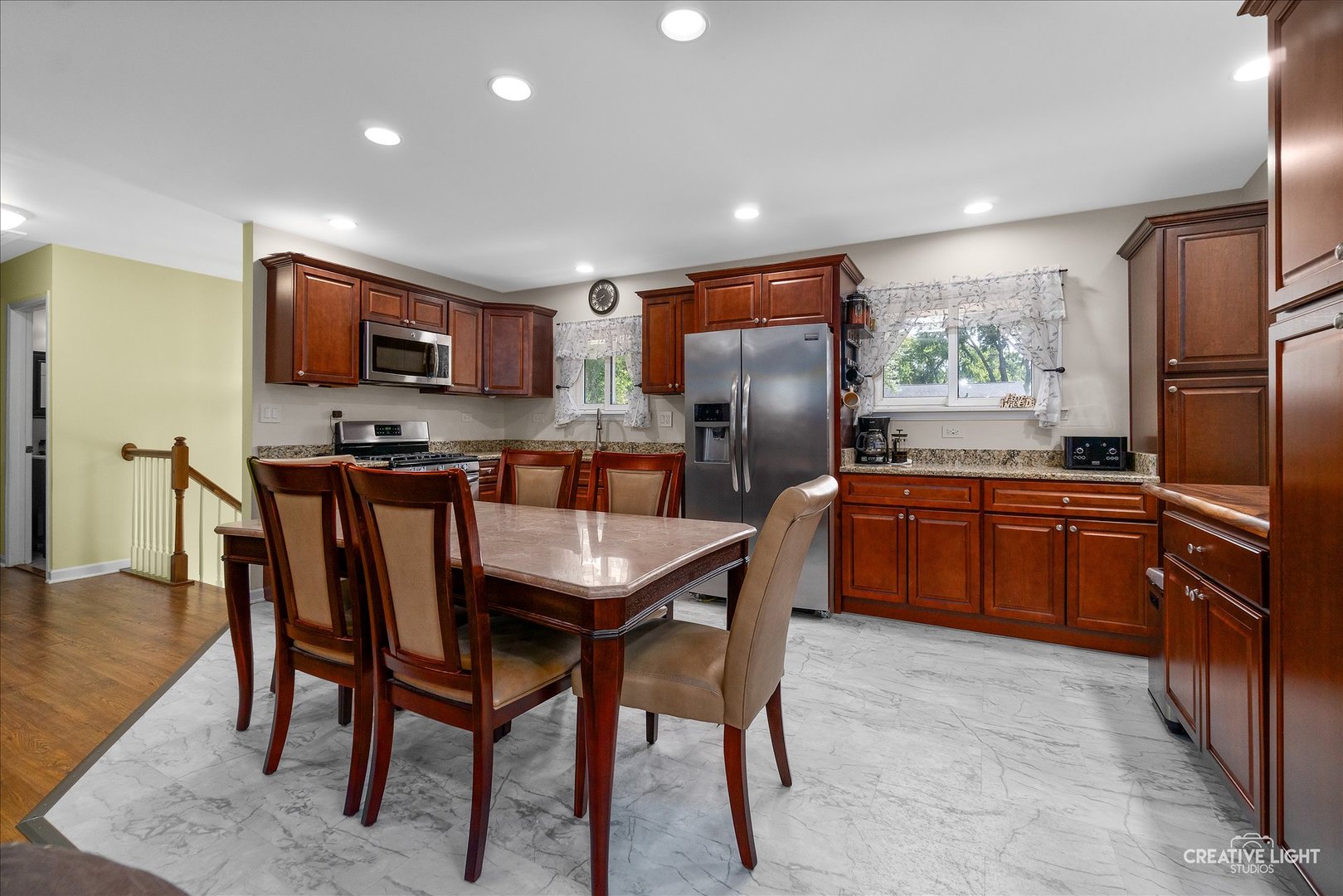129 Oxford Road Bolingbrook, IL 60440 - Photo 5 of 23 a kitchen with stainless steel appliances a refrigerator a stove a sink a dining table and chairs
