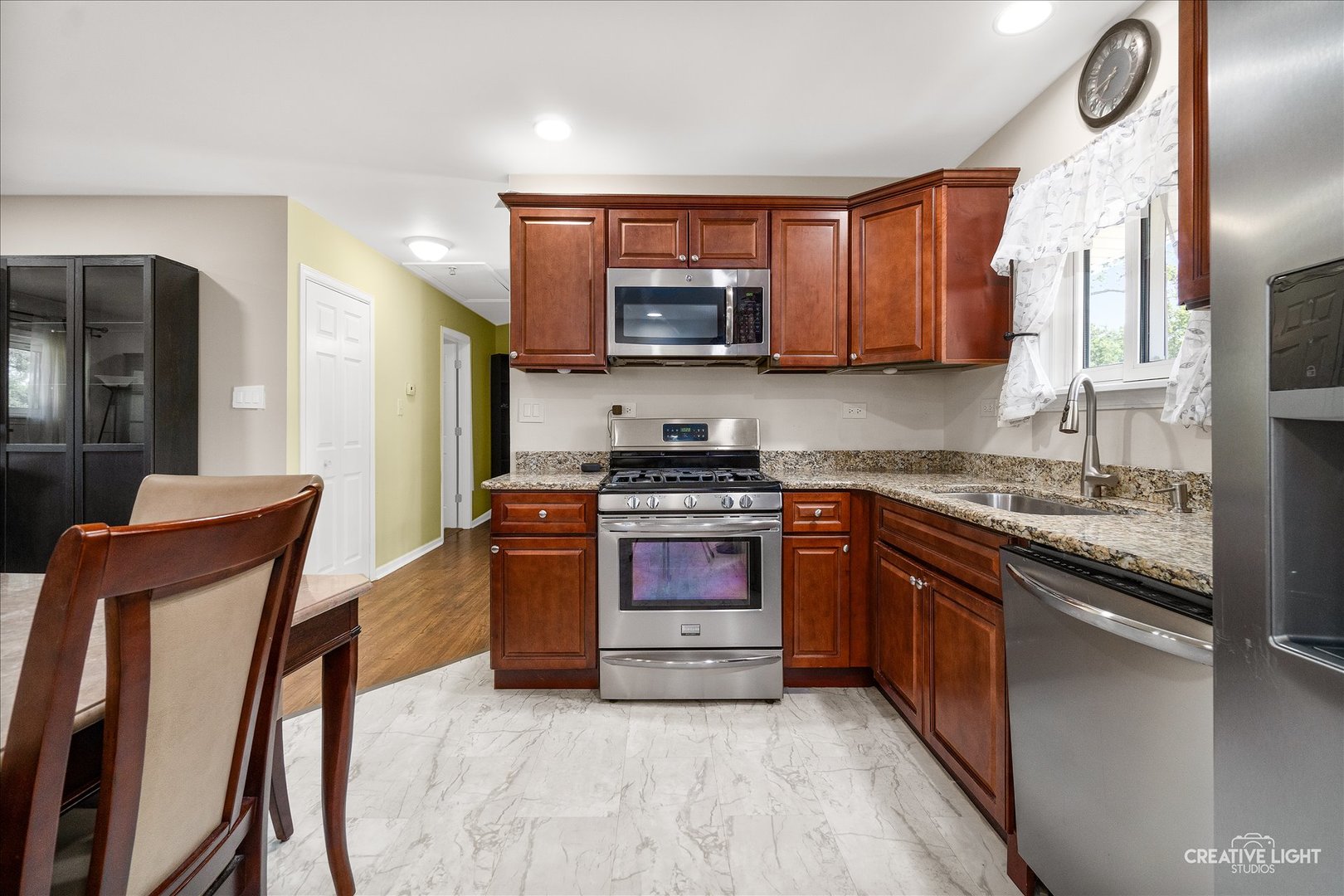 129 Oxford Road Bolingbrook, IL 60440 - Photo 8 of 23 a kitchen with stainless steel appliances granite countertop wooden cabinets a stove top oven a sink and dishwasher