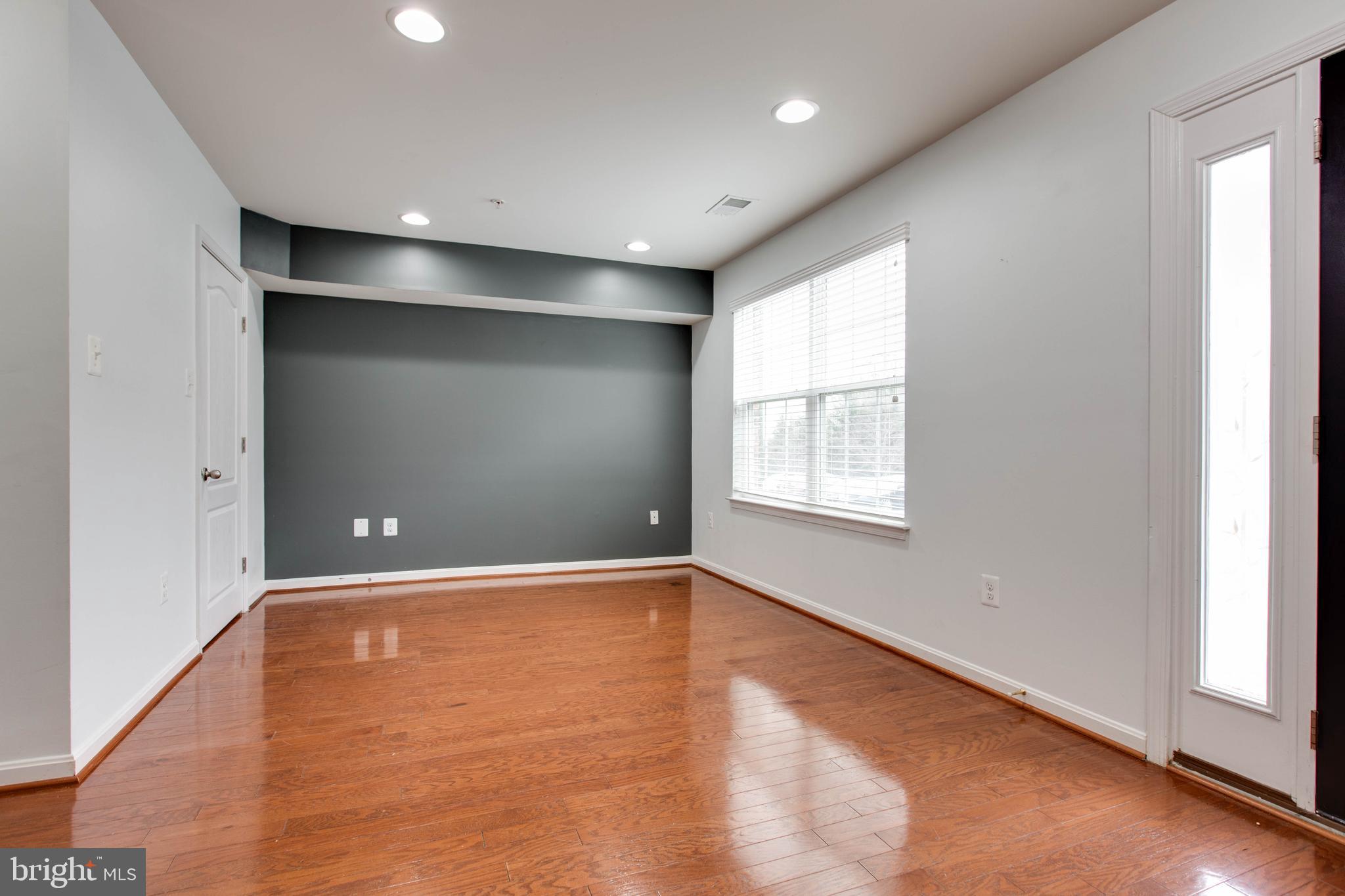 7926 Silver Oak Road Hanover, MD 21076 - Photo 39 of 44 an empty room with wooden floor and windows