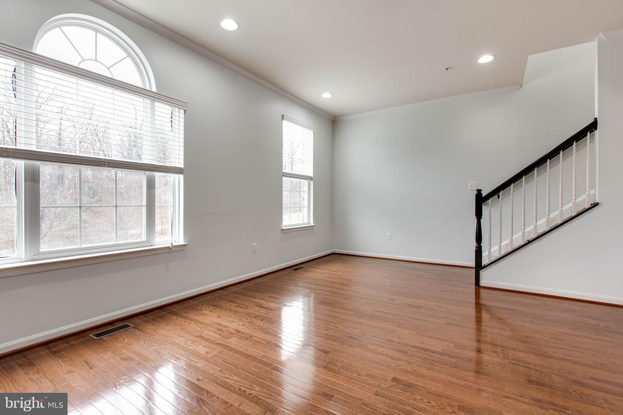 7926 Silver Oak Road Hanover, MD 21076 - Photo 10 of 44 a view of an empty room with wooden floor and a window