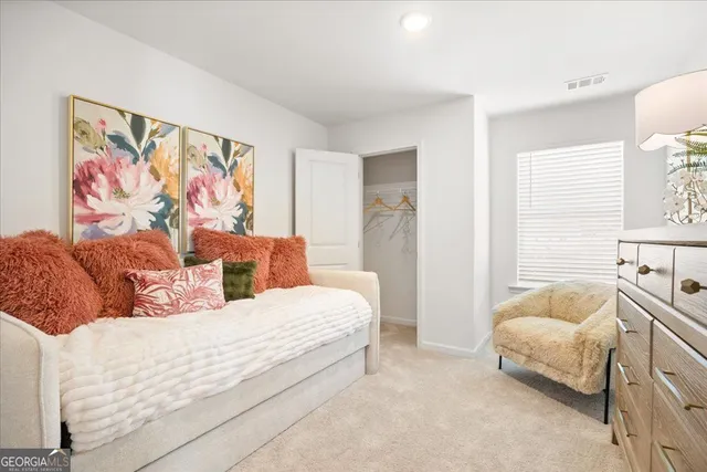 a bedroom with a bed and a painting on the wall