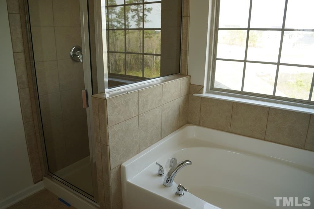 2740 Shepherd Valley Street Raleigh, NC 27610 - Photo 14 of 15 a bath tub sitting next to a window