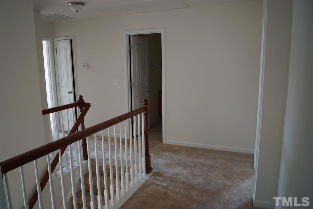 2740 Shepherd Valley Street Raleigh, NC 27610 - Photo 15 of 15 a view of a hallway with wooden floor and stairs