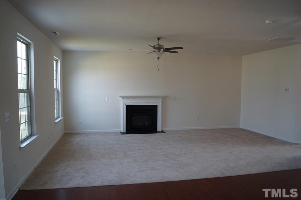 2740 Shepherd Valley Street Raleigh, NC 27610 - Photo 3 of 15 wooden floor in an empty room with a window