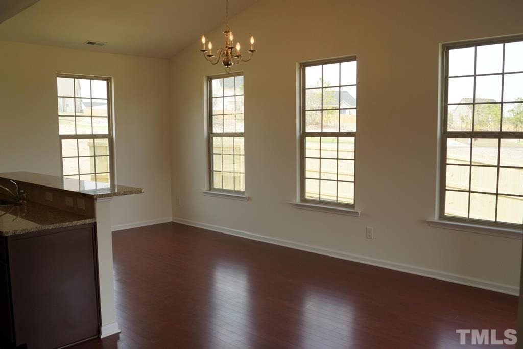 2740 Shepherd Valley Street Raleigh, NC 27610 - Photo 8 of 15 a view of an empty room with wooden floor and a window