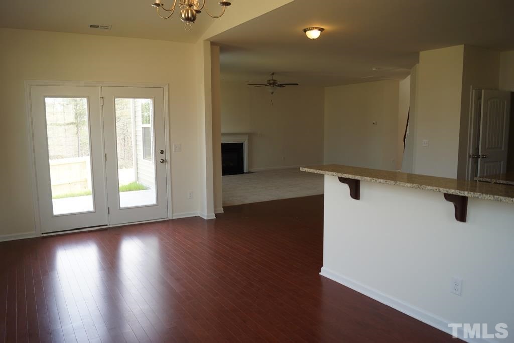 2740 Shepherd Valley Street Raleigh, NC 27610 - Photo 10 of 15 an empty room with wooden floor and windows